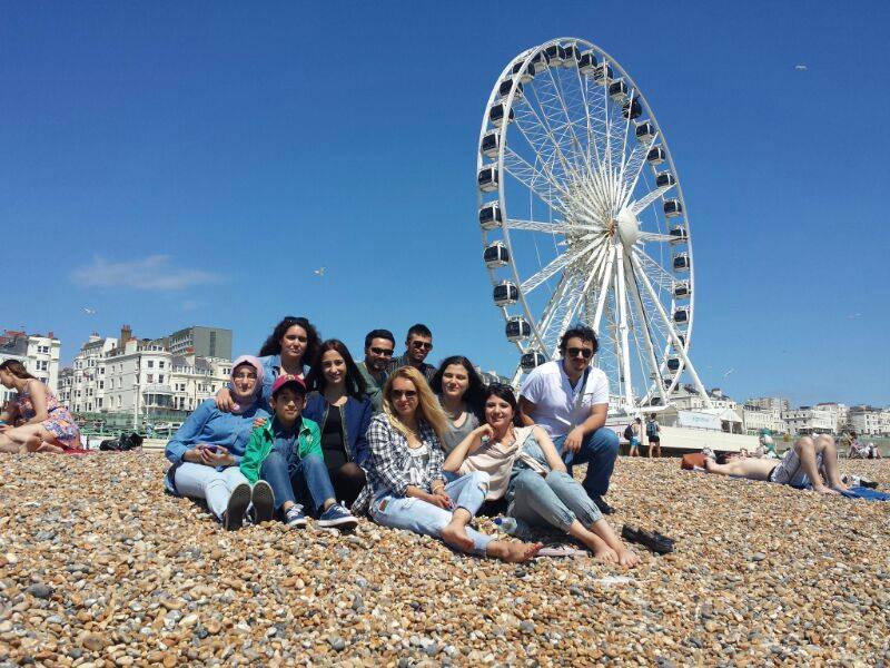 Students at Brighton beach with ferris wheel